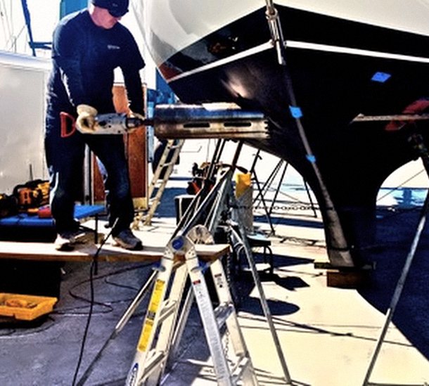 Our technician preparing a sailboat hull for a thruster install