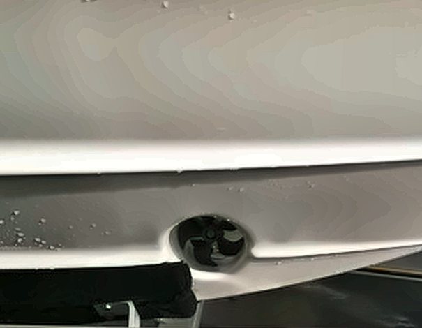 Thruster tunnel and propeller faired into a fiberglass hull
